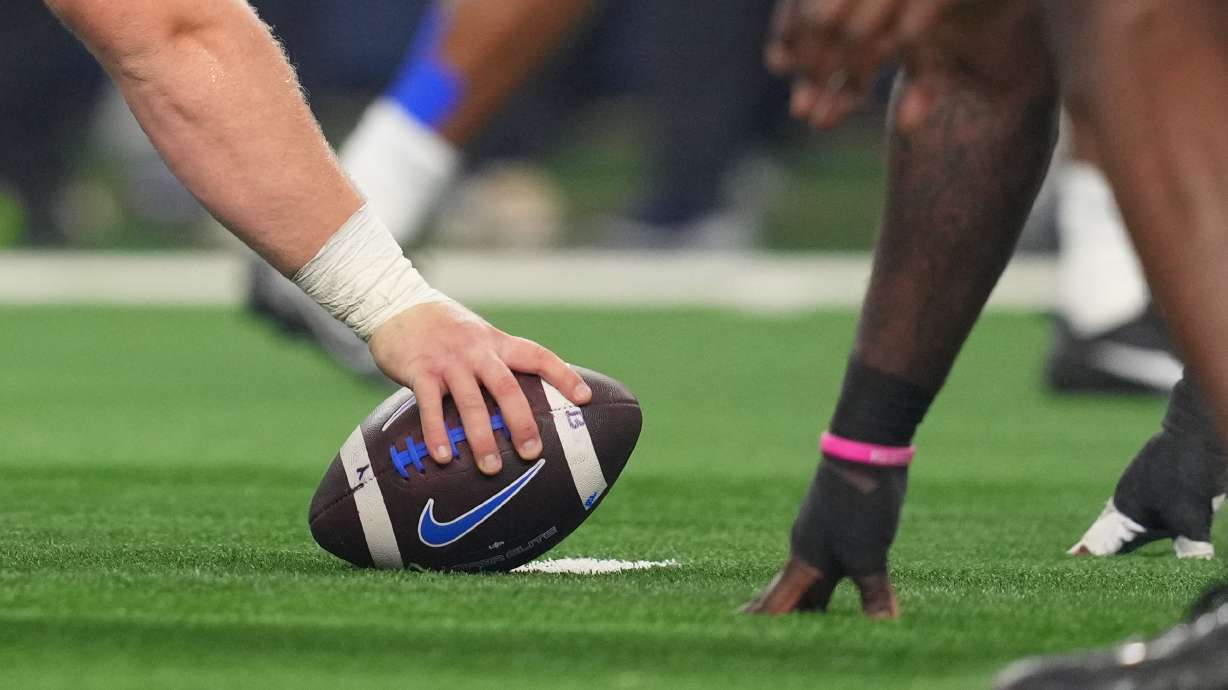 FILE - BYU prepares to snap the ball during the Big 12 Conference championship NCAA college football game between Texas Tech and BYU Saturday, Dec. 6, 2025, in Arlington, Texas.