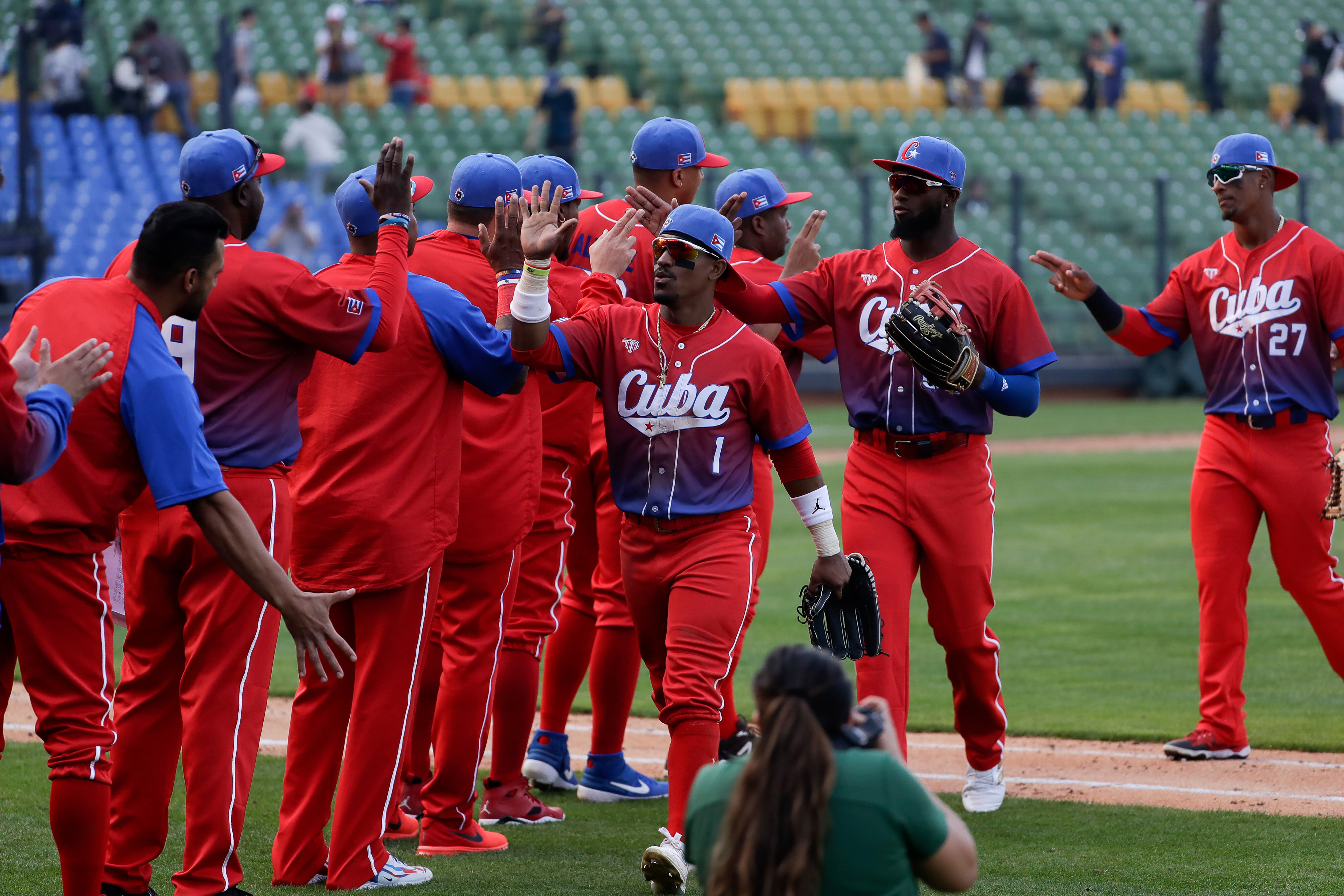 FILE - Cuba's team members celebrate their win over Panama during a Pool A game for the World Baseball Classic (WBC) at Taichung Intercontinental Baseball Stadium in Taichung, Taiwan, March 10, 2023. 