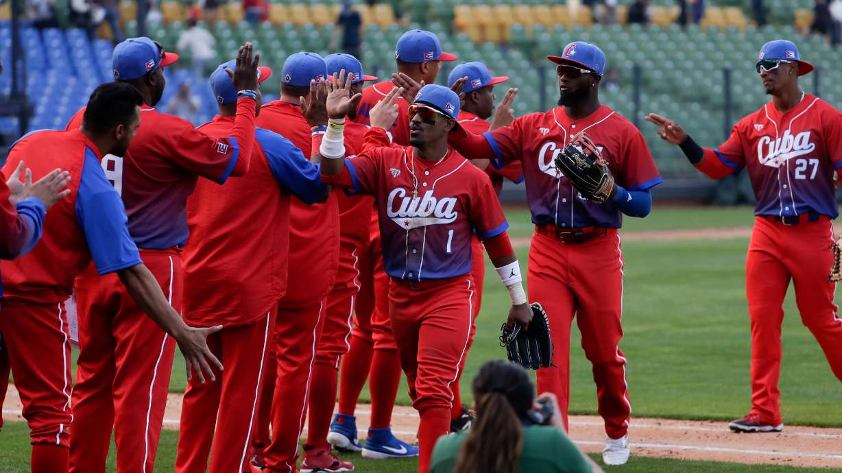 FILE - Cuba's team members celebrate their win over Panama during a Pool A game for the World Baseball Classic (WBC) at Taichung Intercontinental Baseball Stadium in Taichung, Taiwan, March 10, 2023.