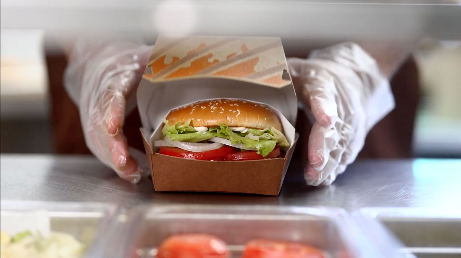 Burger King's updated Whopper, unveiled on Thursday. The updated version now comes in a clamshell box instead of just wrapped in paper after consumers complained their burgers were getting smushed.