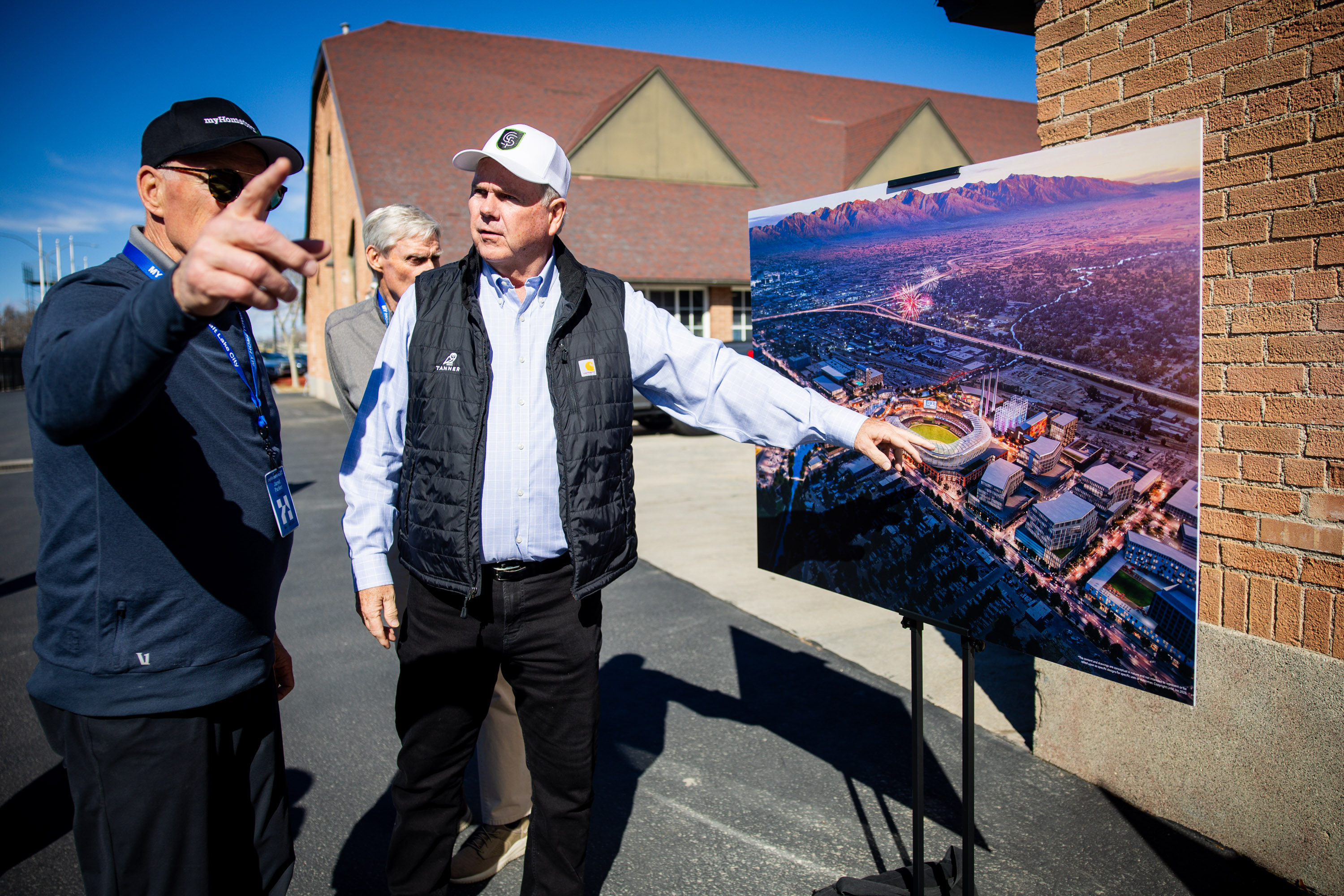 Jared Parker, from myHometown Salt Lake City, left, and Kent Bowman, Cities Strong Foundation board member, right, looks at a rendering before a press conference where community leaders are celebrating the launch of a community-driven plan to revitalize a half-mile stretch of the Jordan River at the Utah State Fairpark in Salt Lake City on Thursday.