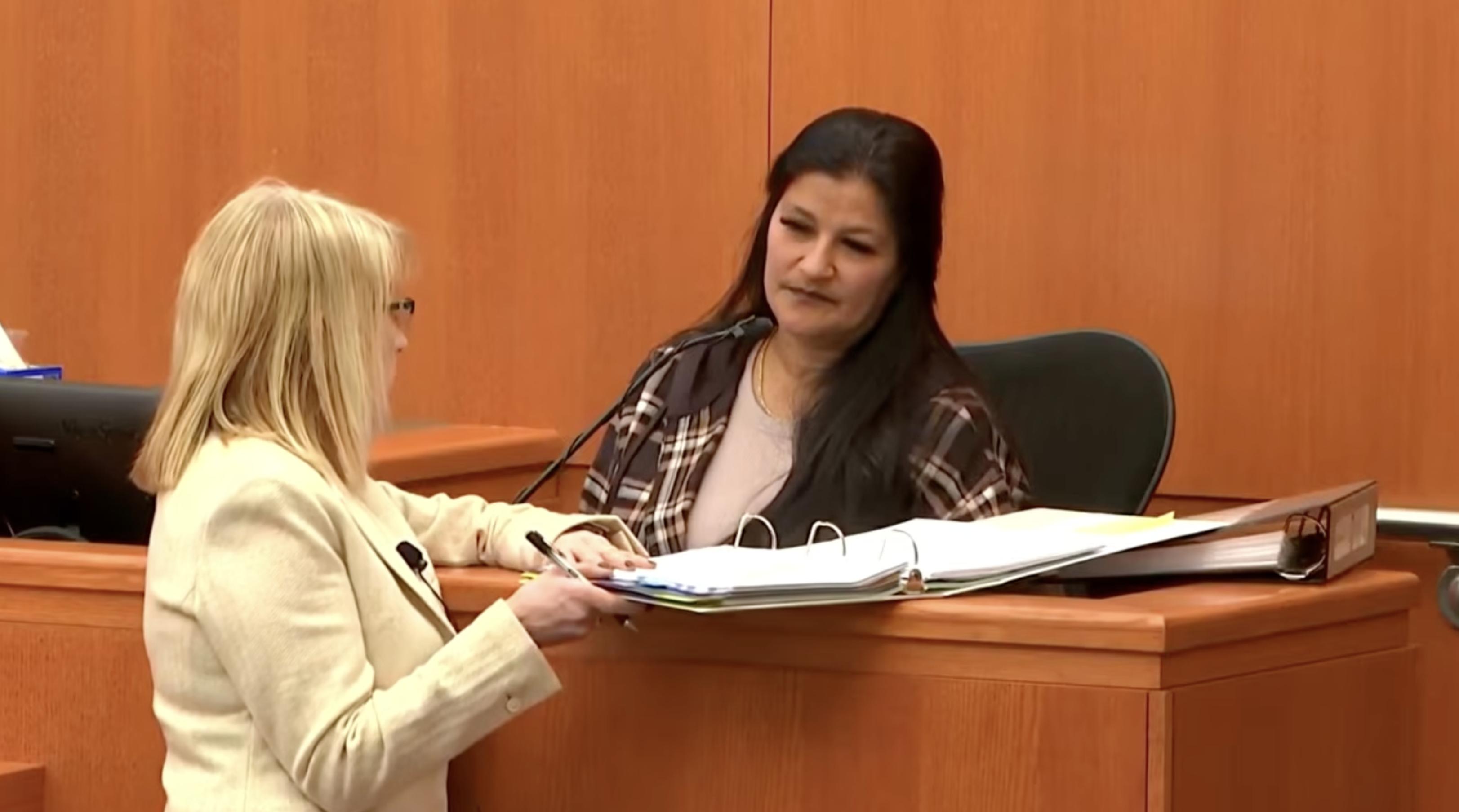Carmen Lauber, who testified about providing drugs to Kouri Richins, looks at a binder with Richins' attorney Wendy Lewis on Thursday.