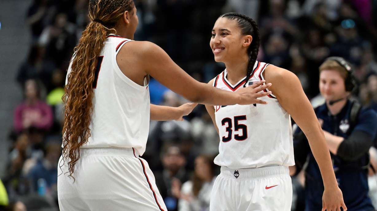 UConn forward Sarah Strong, left, talks with UConn guard Azzi Fudd, right, before tip off in an NCAA college basketball game against Georgetown, Thursday, Feb. 26, 2026, in Hartford, Conn.