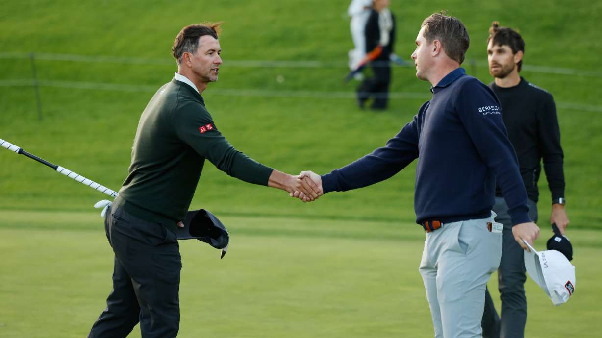 Adam Scott, from Australia, left, shakes hands with Ryan Gerard after finishing the first round of the Genesis Invitational golf tournament at Riviera Country Club, Thursday, Feb. 19, 2026, in the Pacific Palisades area of Los Angeles.