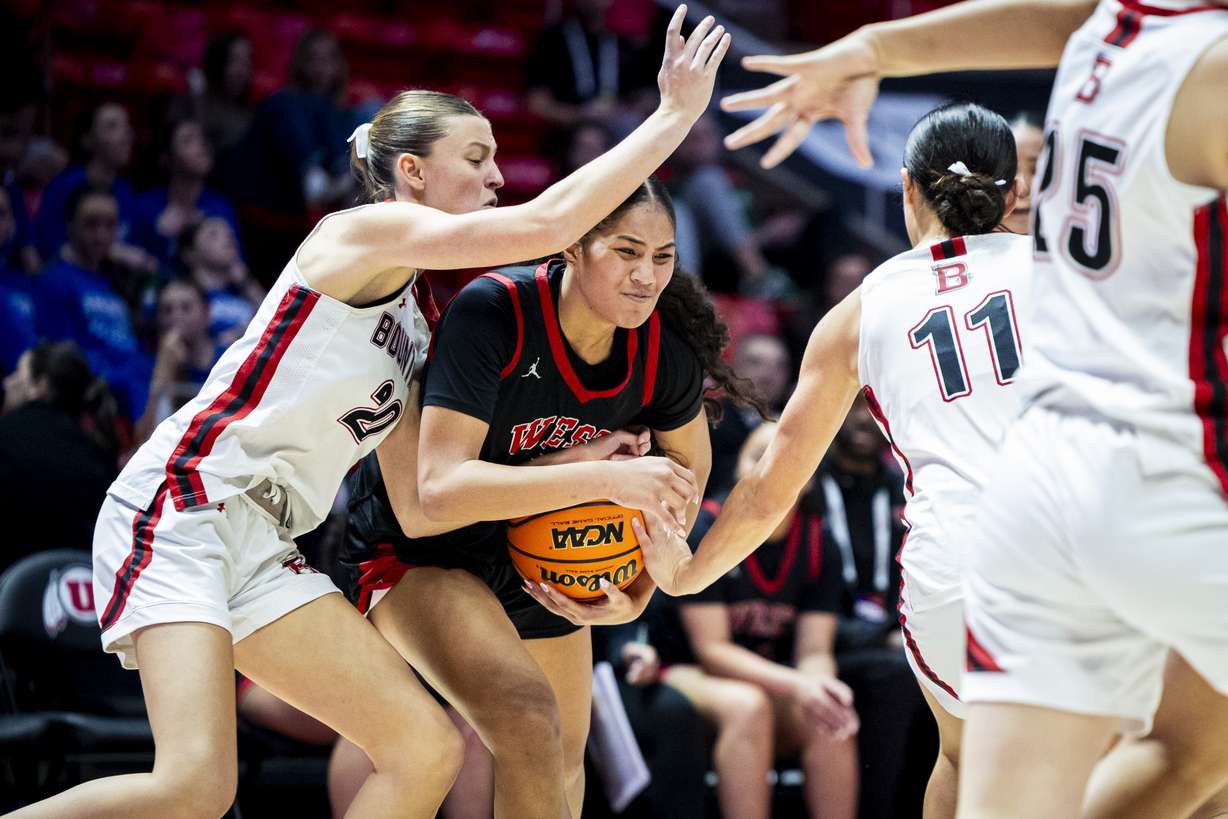 West’s Tiana Fa (4) drives the ball toward the basket while guarded by Bountiful guards Brynna Castleton (20) and Milika Satuala (11) during a game in the semifinals of the 5A girls basketball state tournament held at the Huntsman Center in Salt Lake City on Thursday, Feb. 26, 2026.