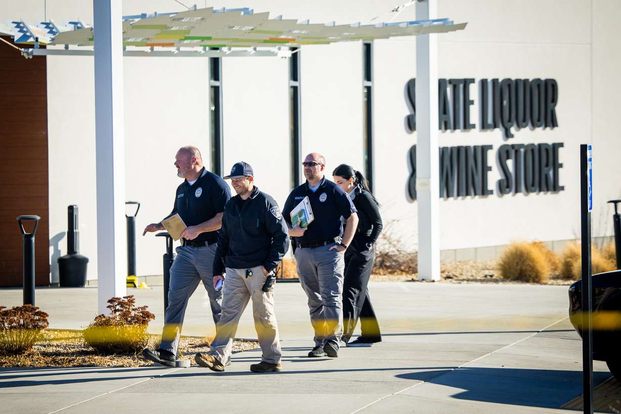Taylorsville police work the scene of a shooting at a state liquor store in Taylorsville on Thursday. The suspected gunman was shot by a Utah Highway Patrol trooper after police say the gunman shot another person at the store.