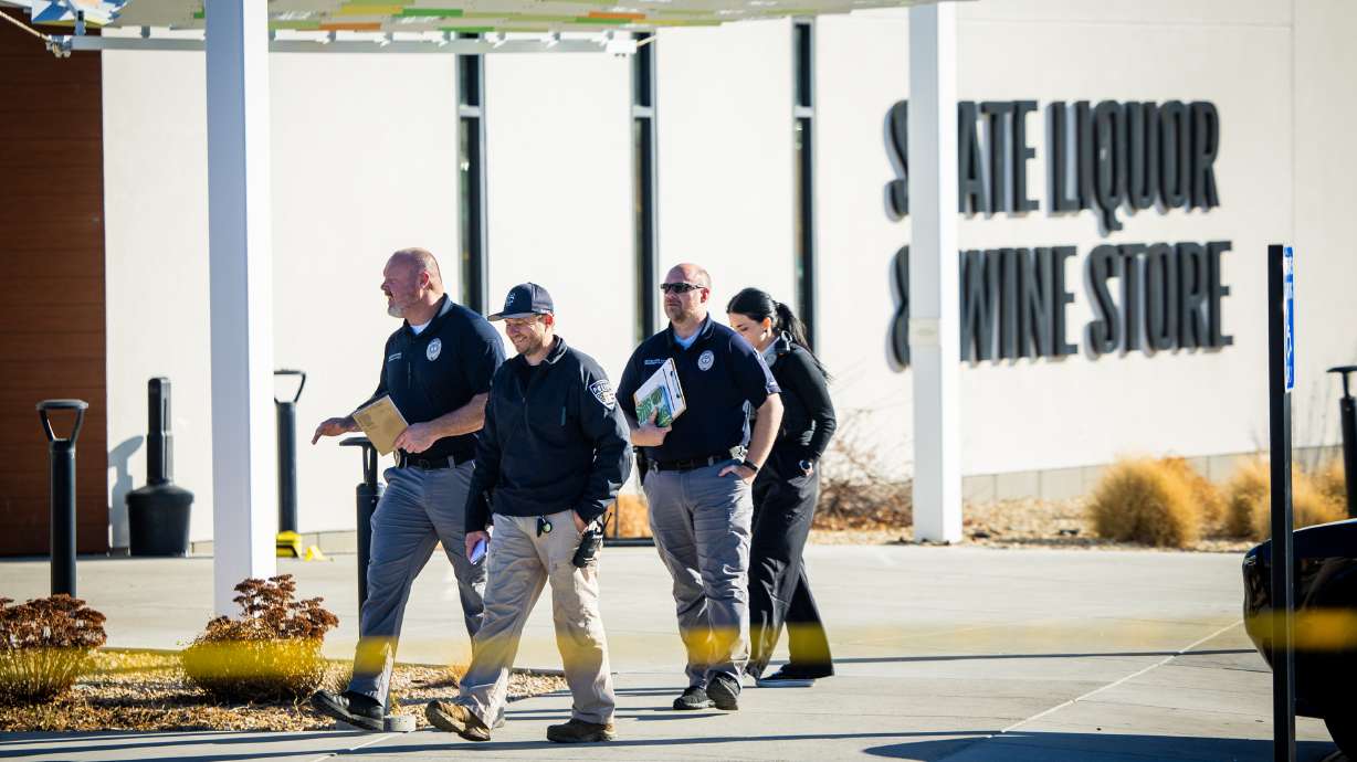 Taylorsville police work the scene of a shooting at a state liquor store on Thursday. A man who was shot by a trooper inside the store has now been formally arrested after being hospitalized.