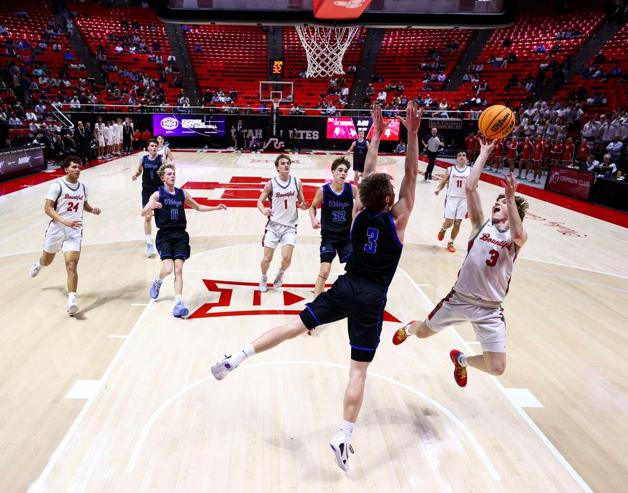 Bountiful guard Wyatt Crane (3) shoots over Pleasant Grove guard Milo Johansson (3) during the first half of the game during the 5A boys basketball semifinals at the Huntsman Center in Salt Lake City on Thursday, Feb. 26, 2026.