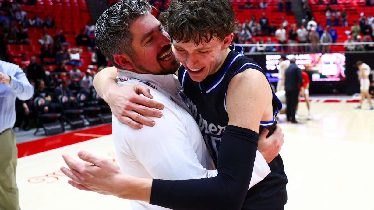 Bingham head coach Kyle Straatman embraces smack forward Parker Snedaker (10) after defeating American Fork 69-65 in overtime during the 6A boys basketball semifinals at the Huntsman Center in Salt Lake City on Thursday, Feb. 26, 2026.
