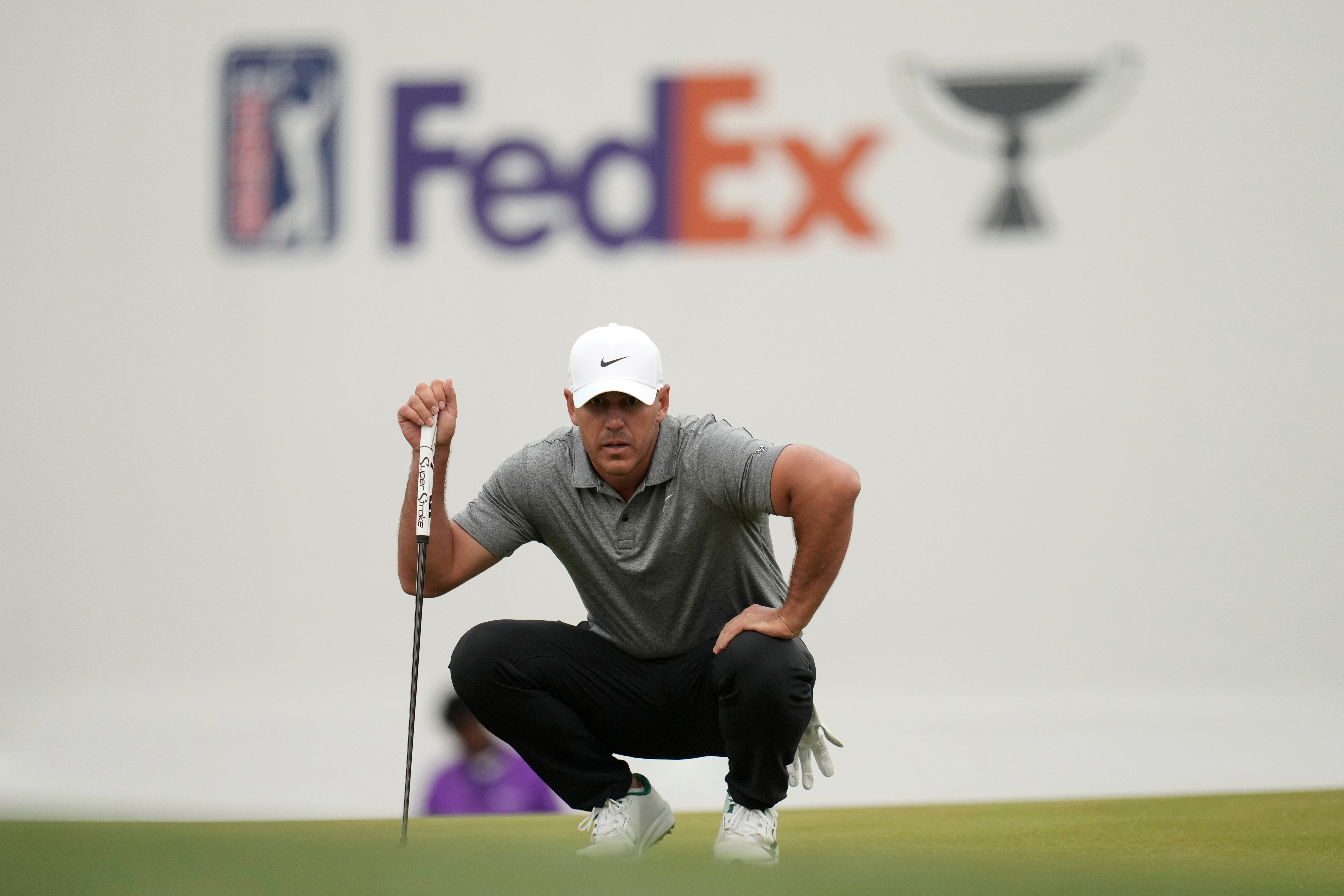 Brooks Koepka lines up a putt at the 16th green during the first round of the Phoenix Open golf tournament at the TPC Scottsdale Stadium Course Thursday, Feb. 5, 2026, in Scottsdale, Ariz.