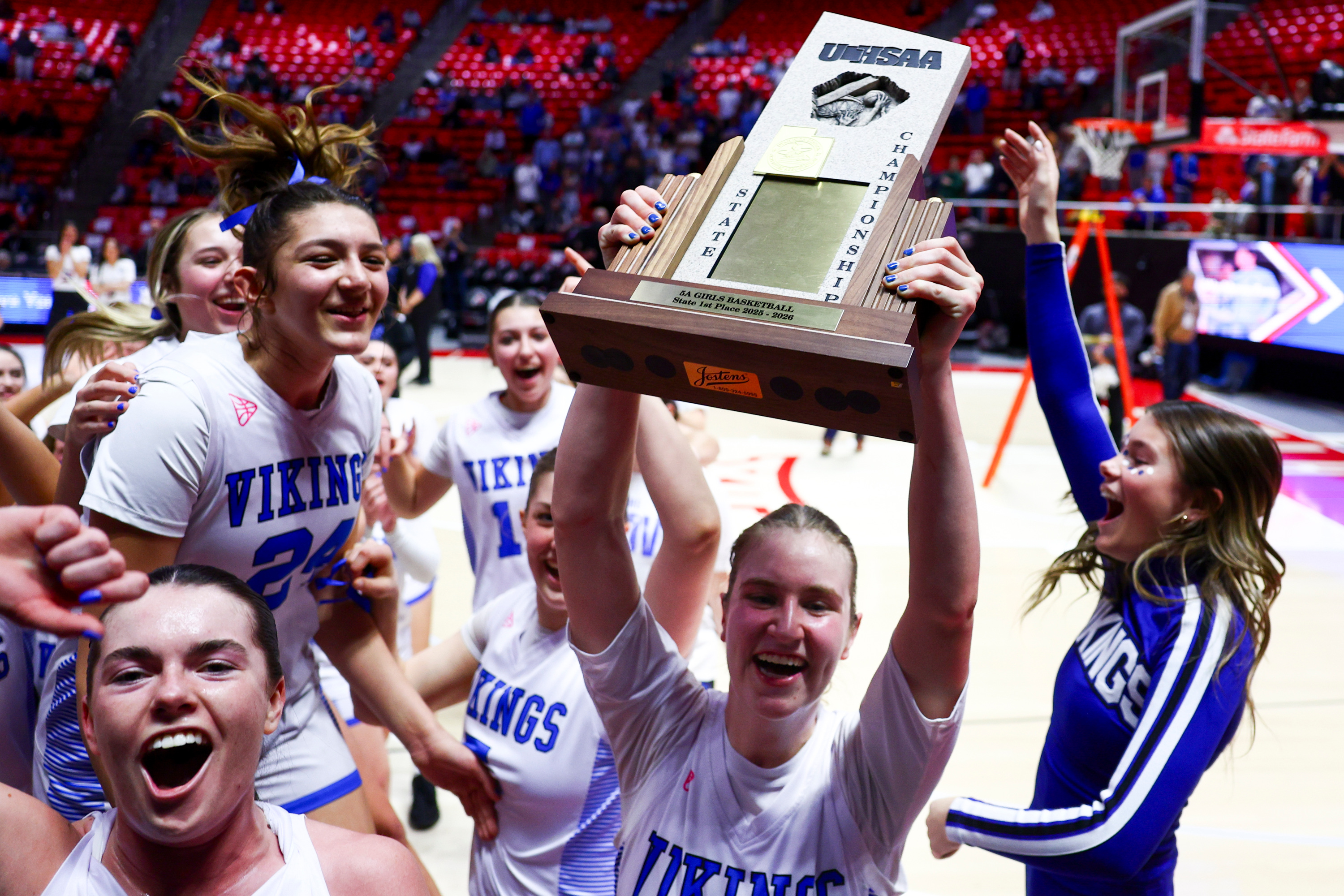 Pleasant Grove guard Tabi Clark (13) lifts the 5A girls basketball state championship trophy in front of the student section after defeating West 45-30 at the Huntsman Center in Salt Lake City on Friday, Feb. 27, 2026.