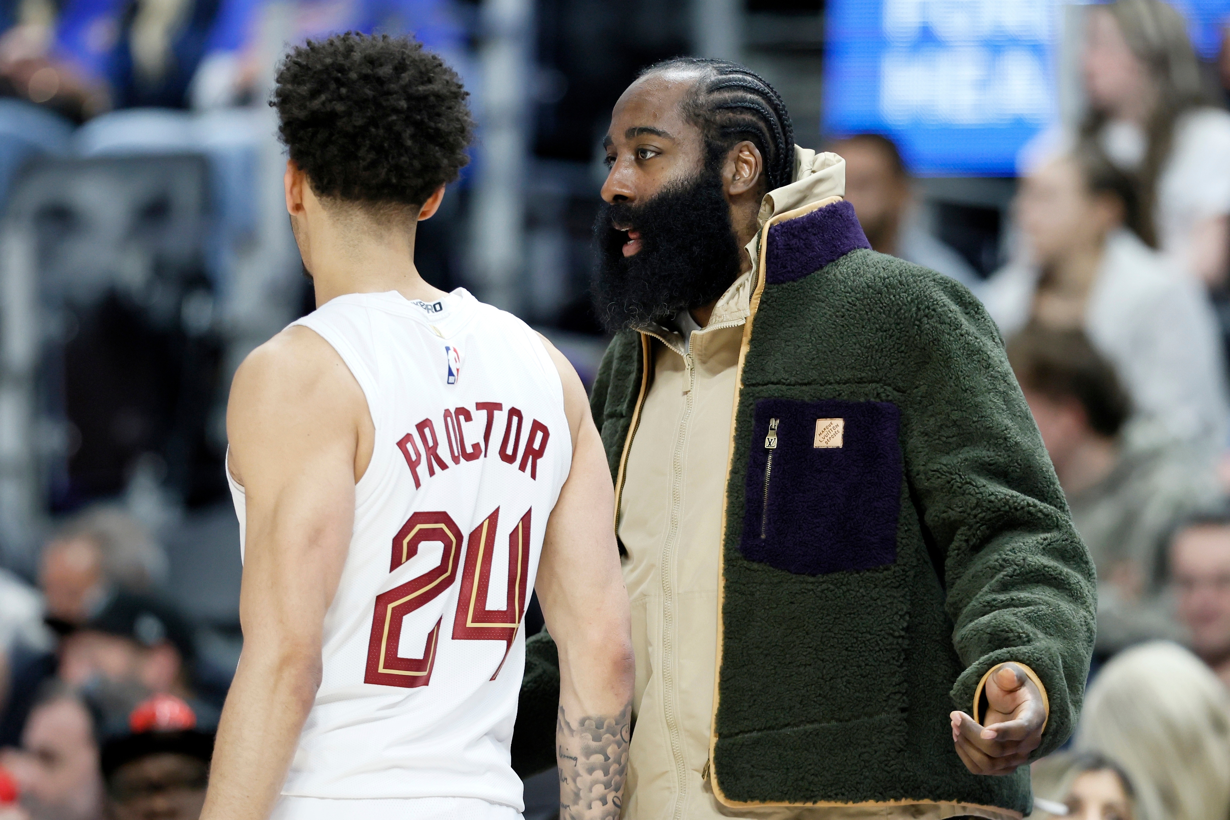 Cleveland Cavaliers guard James Harden, right, who is out injured with a right thumb fracture, talks with Cavaliers guard Tyrese Proctor (24) during the first half of an NBA basketball game Detroit Pistons, Friday, Feb. 27, 2026, in Detroit. 