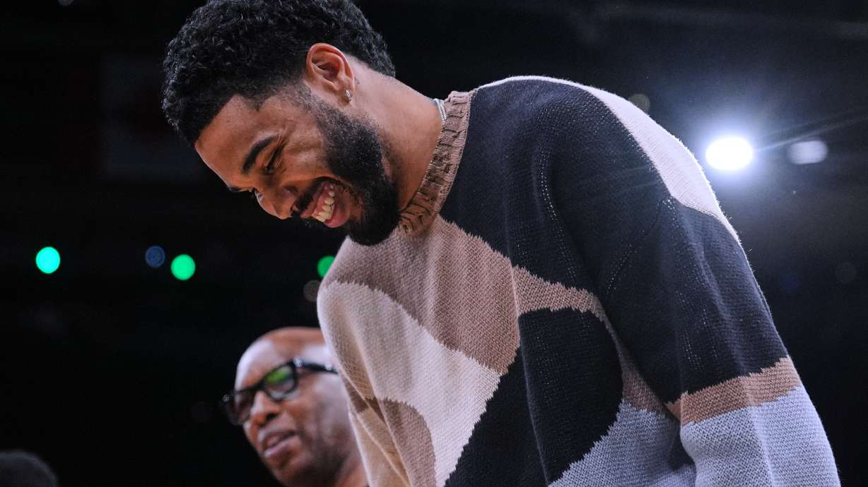 Boston Celtics forward Jayson Tatum, right, jokes with assistant coach Sam Cassell during the first half of an NBA basketball game against the Brooklyn Nets, Friday, Feb. 27, 2026, in Boston.