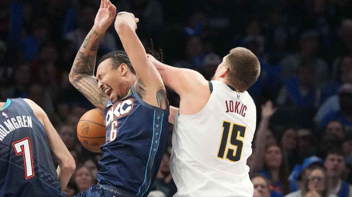 Oklahoma City Thunder forward Jaylin Williams (6) falls into Denver Nuggets center Nikola Jokic (15) as he goes after a rebound during the second half of an NBA basketball game, Friday, Feb. 27, 2026, in Oklahoma City.