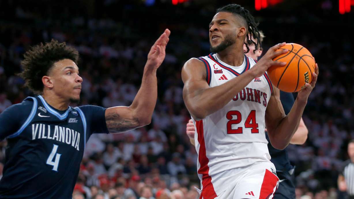Villanova guard Tyler Perkins, left, defends St. John's forward Zuby Ejiofor during the second half of an NCAA college basketball game Saturday, Feb. 28, 2026, in New York.