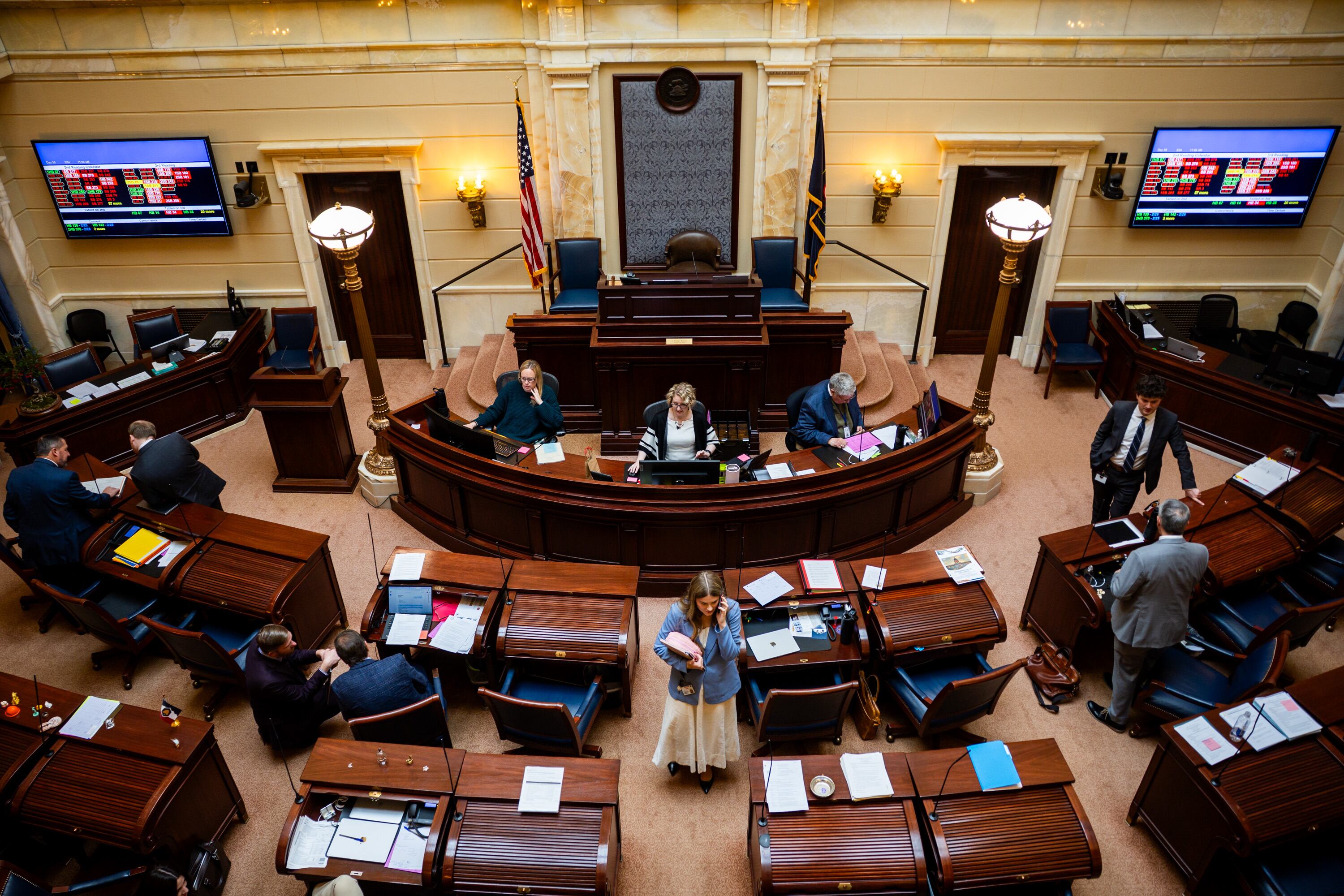 People linger before breaking for lunch in the Senate Chamber during the legislative session at the Capitol in Salt Lake City on Feb. 24.