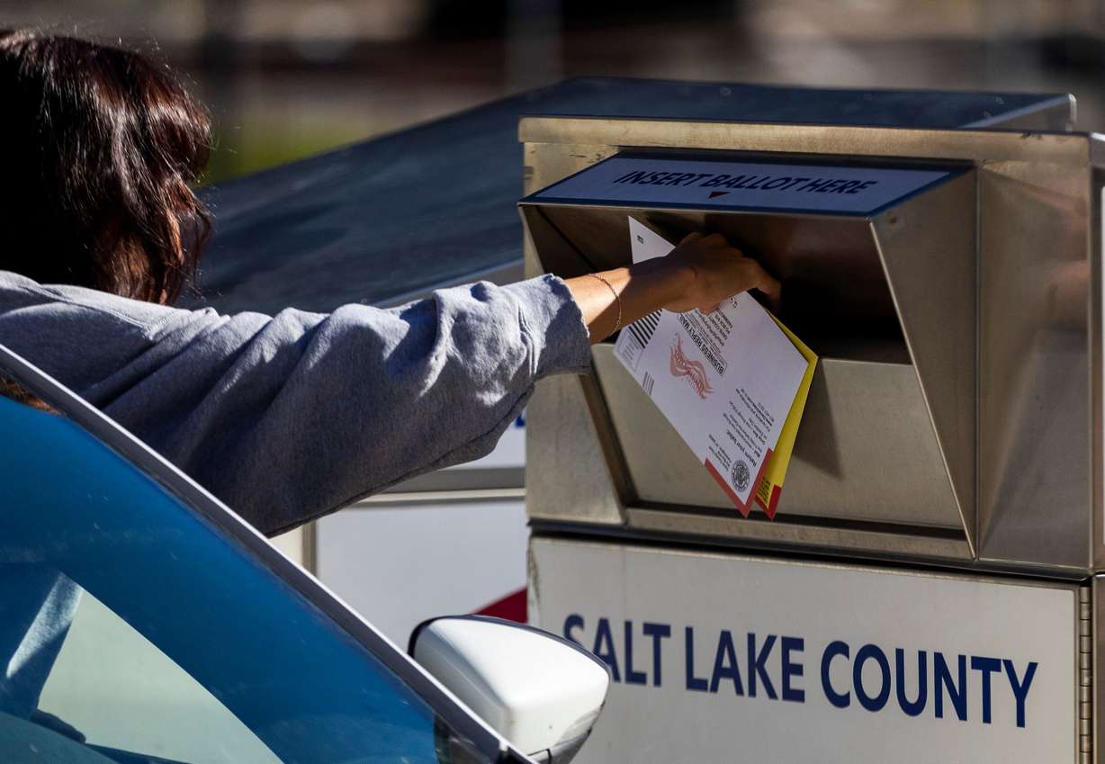 A voter drops off a ballot outside of the Salt Lake County Government Center in Salt Lake City on Nov. 4, 2024.