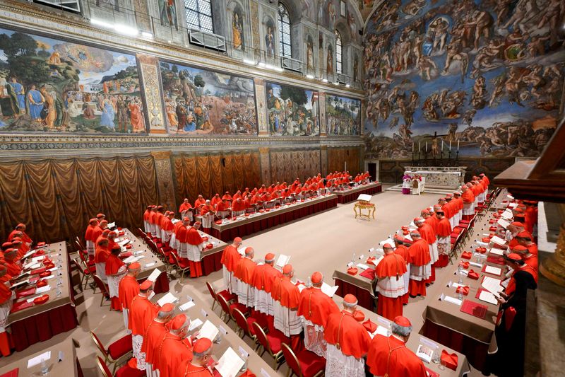 Pope Leo XIV stands in the Sistine Chapel among cardinals after being elected, at the Vatican, May 8, 2025. The secret conclave that elected Pope Leo head of the Catholic Church last May was interrupted when one of the 133 cardinals involved ​was found carrying a cellphone, a massive security breach, a book released on Sunday revealed.