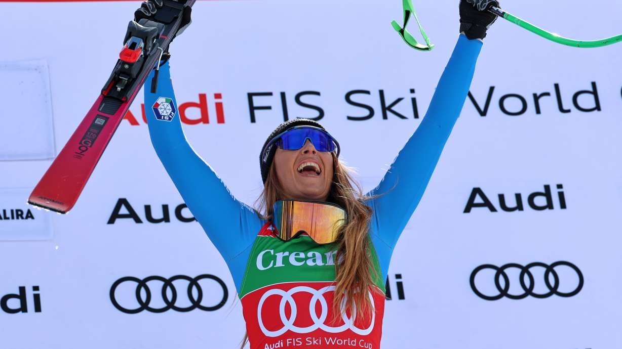 Italy's Sofia Goggia celebrates on the podium winning a women's World Cup super-G race, in Soldeu, Andorra, Sunday, March 1, 2026.