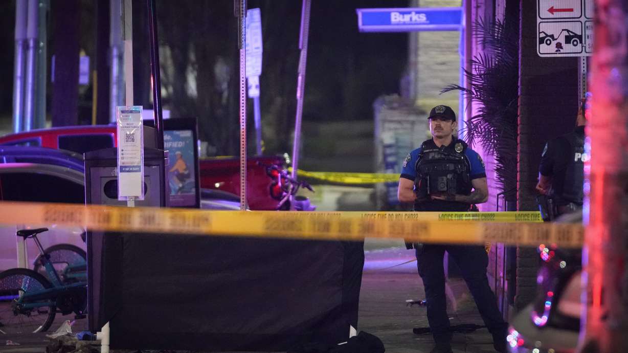 An Austin police officer guards the scene on West 6th Street at West Avenue after a shooting, Sunday, in Austin, Texas.