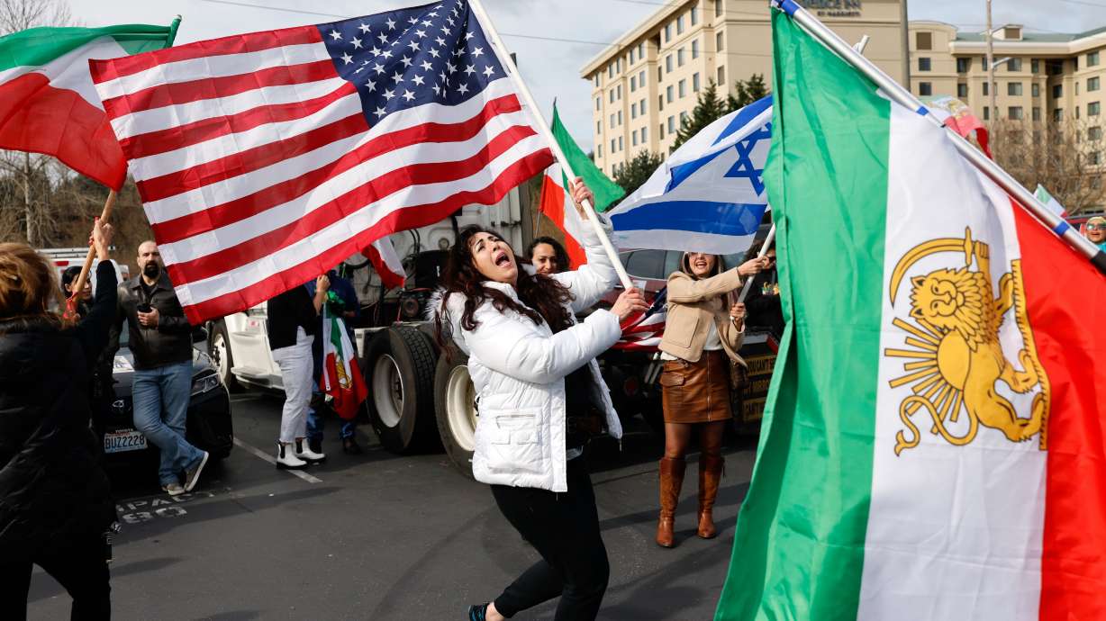 Karla Mohtashemi, center, celebrates as Voice of Iran hosts a car rally in Bellevue, Wash., on Saturday, Feb. 28, 2026, in response to the U.S. bombing of Iran.