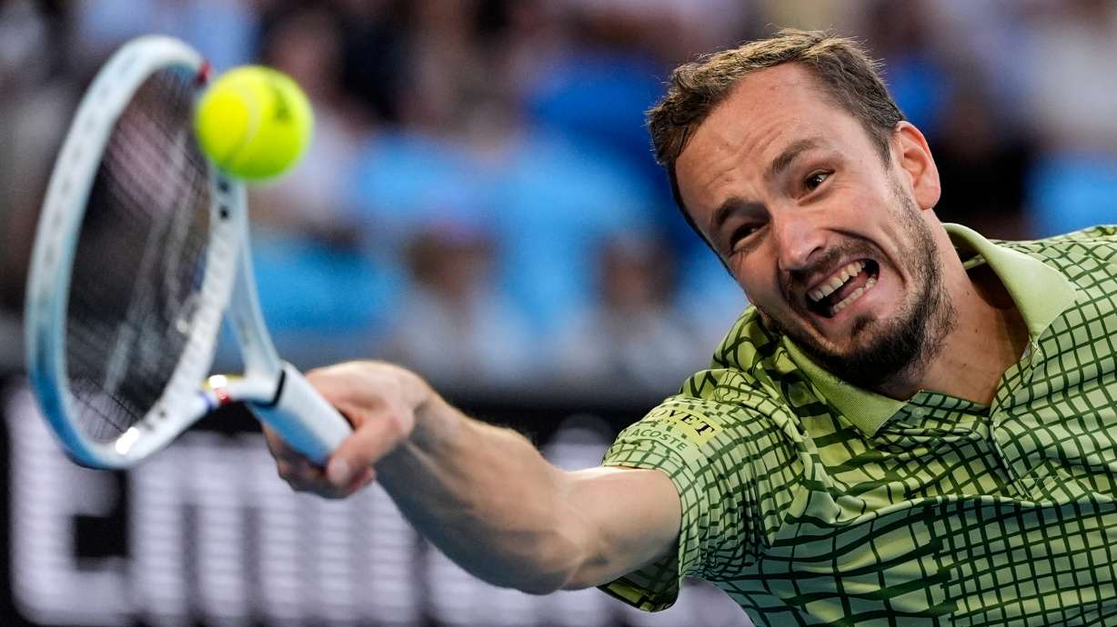 FILE - Daniil Medvedev of Russia plays a forehand return to Learner Tien of the U.S. during their fourth round match at the Australian Open tennis championship in Melbourne, Australia, Jan. 25, 2026.