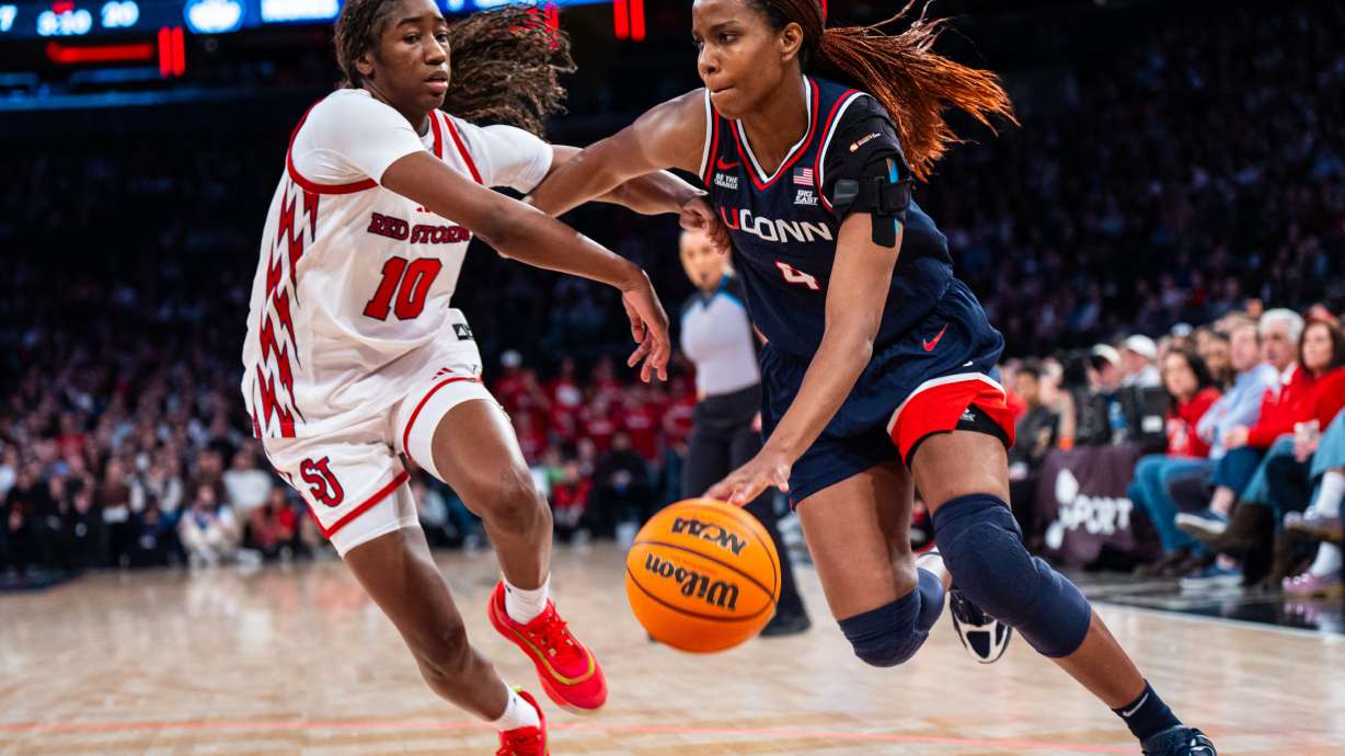 UConn guard Blanca Quinonez (4), guarded by St. John's guard Brooke Moore (10), heads toward the basket during the first half of an NCAA college basketball game, Sunday, March 1, 2026, in New York.