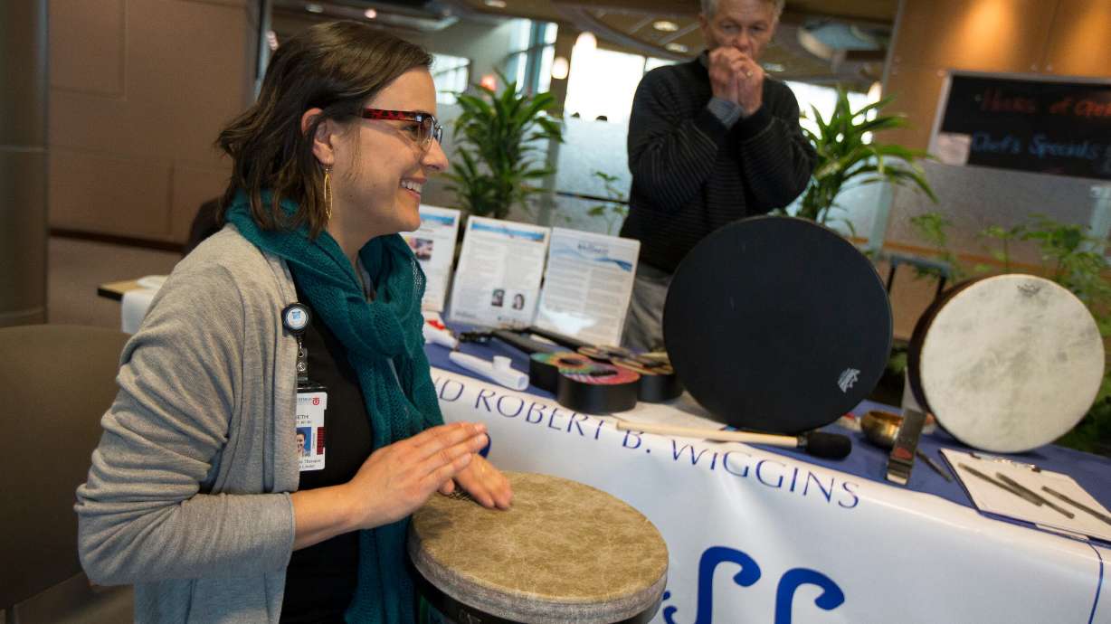 Beth Hardy, left, a music therapist at the Huntsman Cancer Institute, plays a tune with cancer survivor John Matro, of Park City, at the institute in Salt Lake City on Jan. 26, 2018.