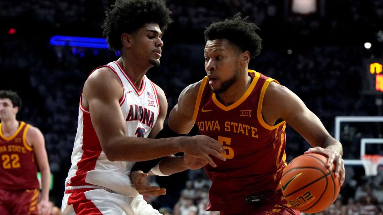 Iowa State forward Joshua Jefferson (5) drives on Arizona forward Koa Peat during the first half of an NCAA college basketball game, Monday, March 2, 2026, in Tucson, Ariz.