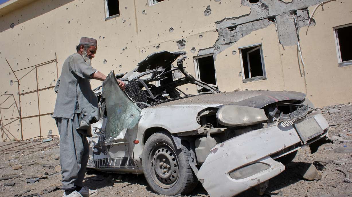 A man inspects a car damaged after a Pakistani strike in on a refugee camp in Takhta Pul district, Kandahar province, Afghanistan, Saturday. Afghan forces attacked Pakistani military positions along the border early on Tuesday, triggering intense clashes that left 67 Afghan troops and one Pakistani soldier dead, officials in Islamabad said.