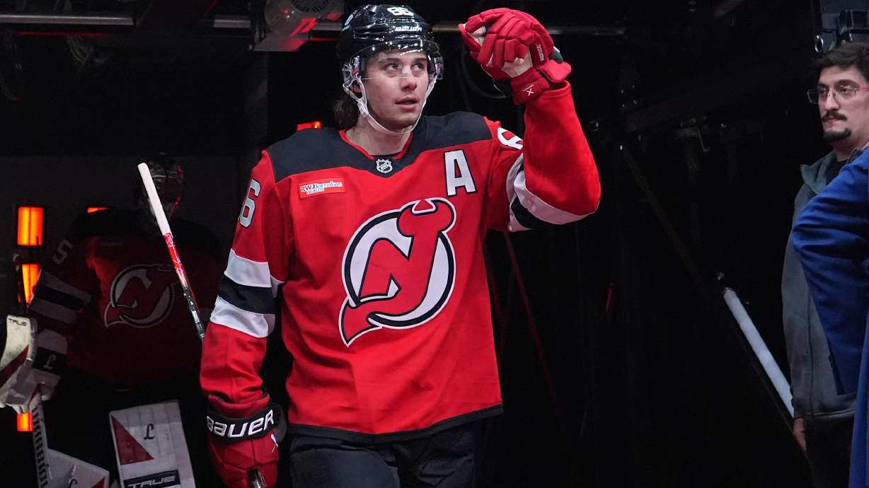 New Jersey Devils' Jack Hughes (86) walks toward the ice to warm up before an NHL hockey game against the Buffalo Sabres Wednesday, Feb. 25, 2026, in Newark, N.J.