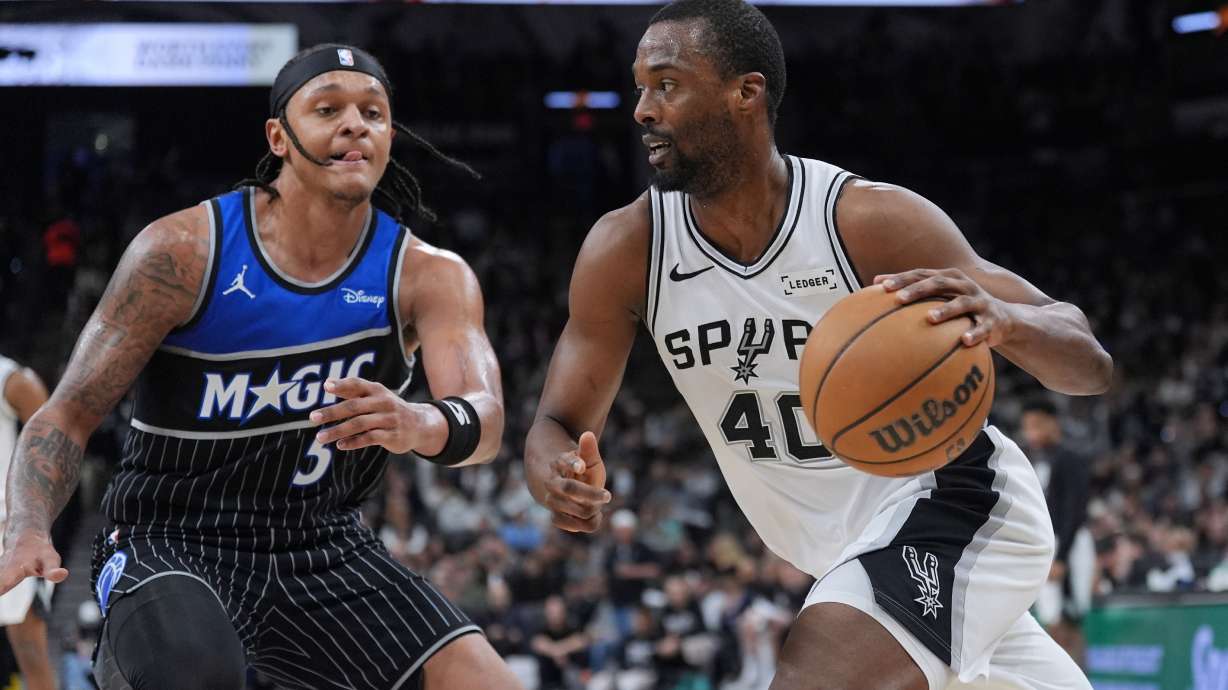 San Antonio Spurs forward Harrison Barnes (40) drives against Orlando Magic forward Paolo Banchero (5) during the second half of an NBA basketball game in San Antonio, Sunday, Feb. 1, 2026.