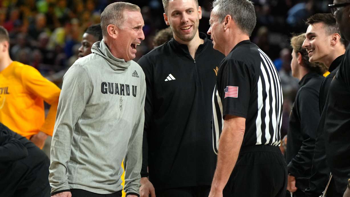 Arizona State head coach Bobby Hurley talks with a referee during the first half of an NCAA college basketball game against Kansas, Tuesday, March 3, 2026, in Tempe, Ariz.