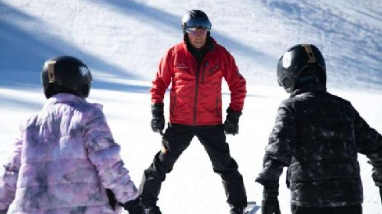 Bob Carlson demonstrates how to make a “pizza” with his skis for Lexi Ward and Greyson Ward at Kelly Canyon on Friday. Eighty-eight-year-old Carlson can ski with anybody, and when he isn't practicing his carving on the slopes, he's teaching inexperienced skiers how to gain their footing at Kelly Canyon.
