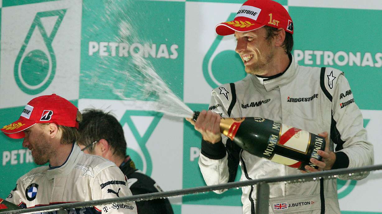 FILE - Brawn GP Formula One driver Jenson Button of Britain, right, BMW Sauber Formula One driver Nick Heidfeld of Germany celebrate during the award ceremony of the Malaysia Formula One Grand Prix at the Sepang racetrack in Kuala Lumpur, Sunday, April 5, 2009.
