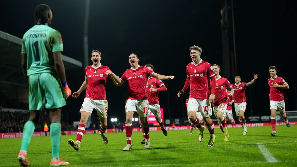 FILE - Wrexham's goalkeeper Arthur Okonkwo, left, celebrates with teammates after a penalty shootout at the end of the English FA Cup third round soccer match between Wrexham and Nottingham Forest in Wrexham, Wales, Friday, Jan. 9, 2026.