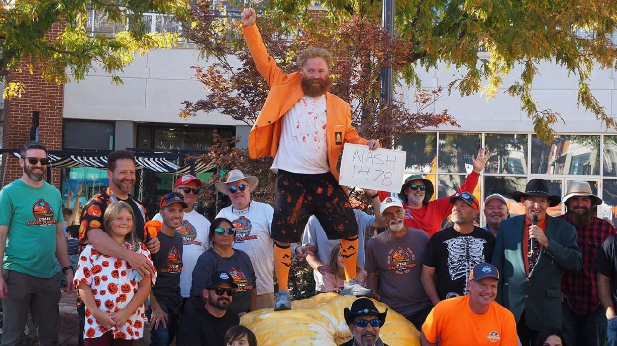 Clint Nash stands on his award-winning pumpkin in 2023. Nash, along with giant pumpkin growers from around the world, will come to Utah this weekend for the 2026 International Growers Convention.