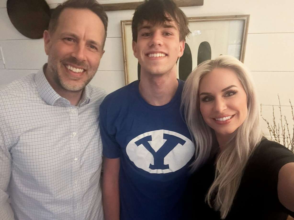 Owen Johansen is pictured with his father, Aaron Johansen, and his mother, Talai Johansen, at their home in Oakton, Va., Wednesday. Owen Johansen was conditionally admitted to Brigham Young University after the school sent out nine mistaken acceptances.