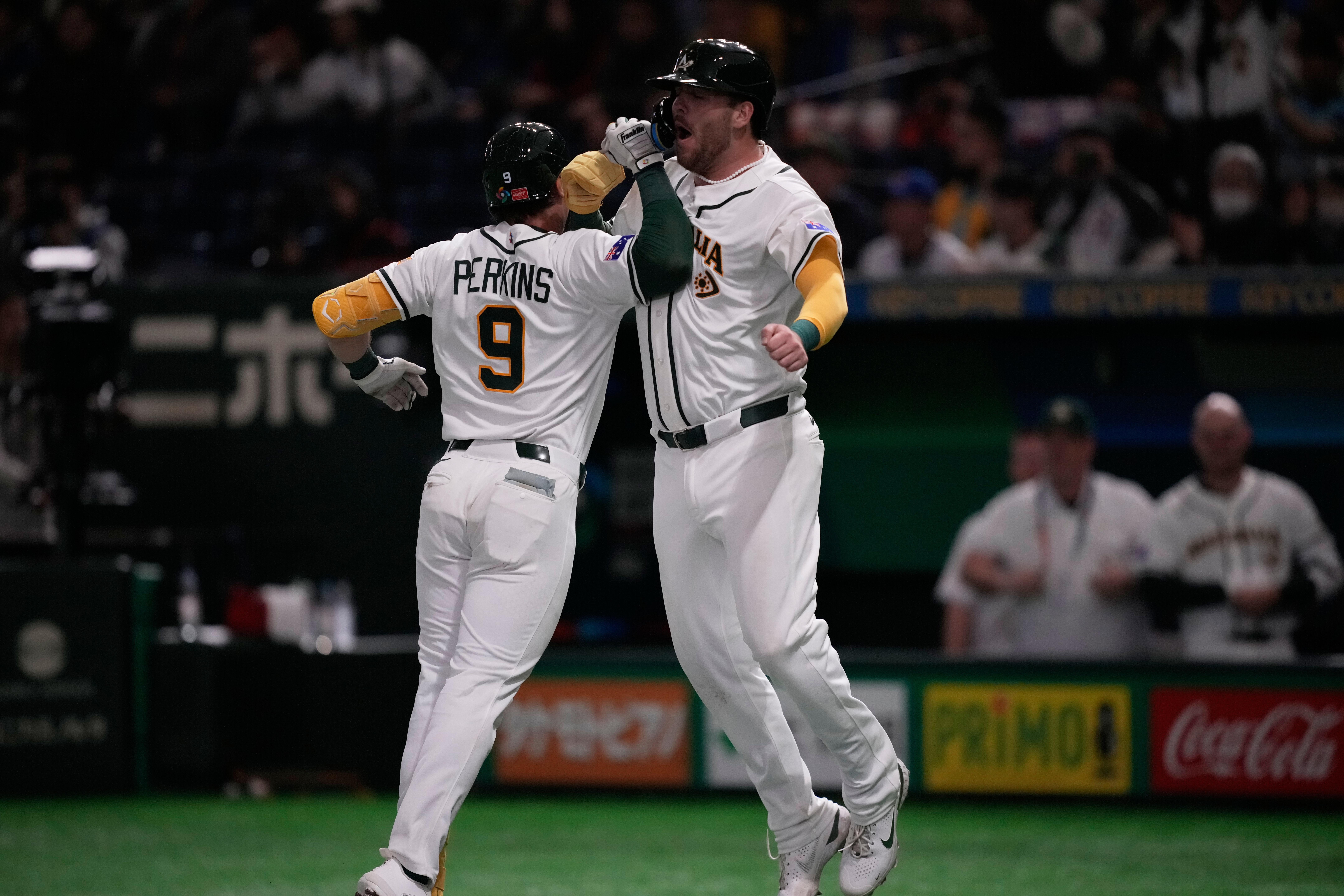 Australia's catcher Robbie Perkins, left, celebrates with Australia's Rixon Wingrove after hits a two-run home run against Taiwan in the fifth inning of a World Baseball Classic game in Tokyo, Thursday, March 5, 2026.