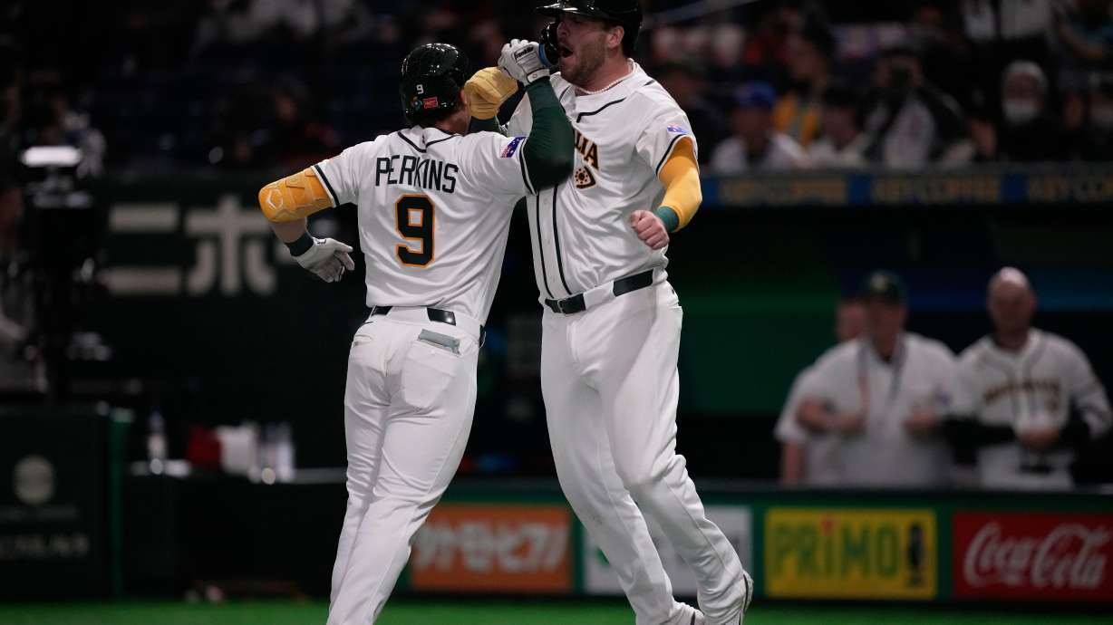 Australia's catcher Robbie Perkins, left, celebrates with Australia's Rixon Wingrove after hits a two-run home run against Taiwan in the fifth inning of a World Baseball Classic game in Tokyo, Thursday, March 5, 2026.