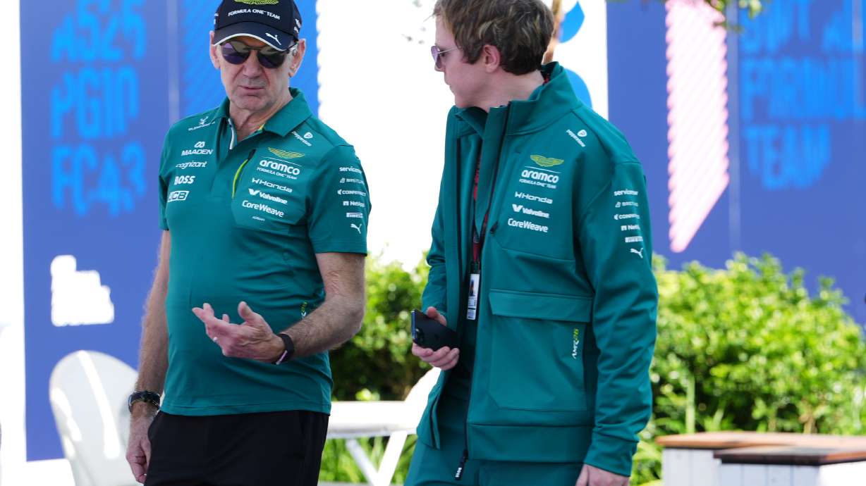 Aston Martin team principal Adrian Newey, left, talks with a team member as he arrives at the track ahead of the Australian Formula One Grand Prix at Albert Park, in Melbourne, Australia, Thursday, March 5, 2026.