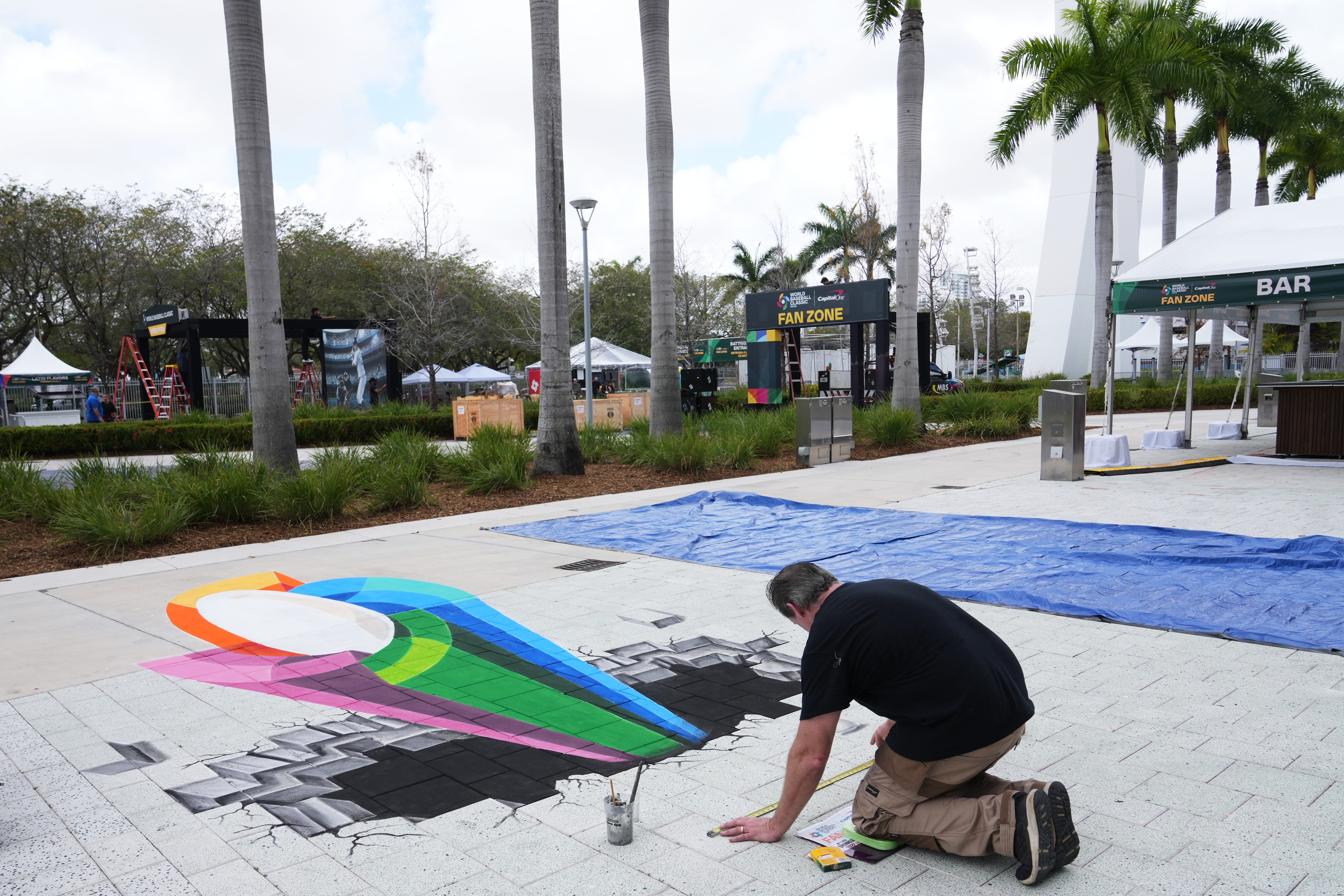 Artist Mike Macaulay paints a World Baseball Classic logo outside of loanDepot Park in advance of the World Baseball Classic, Thursday, March 5, 2026, in Miami. 