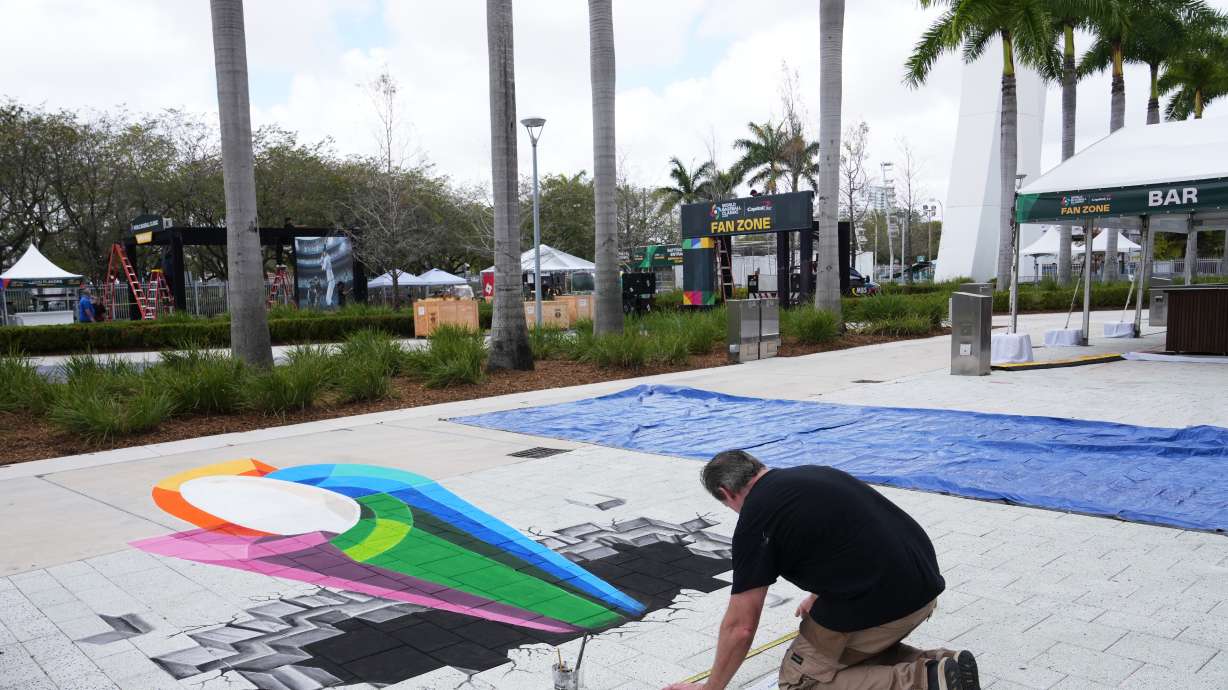 Artist Mike Macaulay paints a World Baseball Classic logo outside of loanDepot Park in advance of the World Baseball Classic, Thursday, March 5, 2026, in Miami.