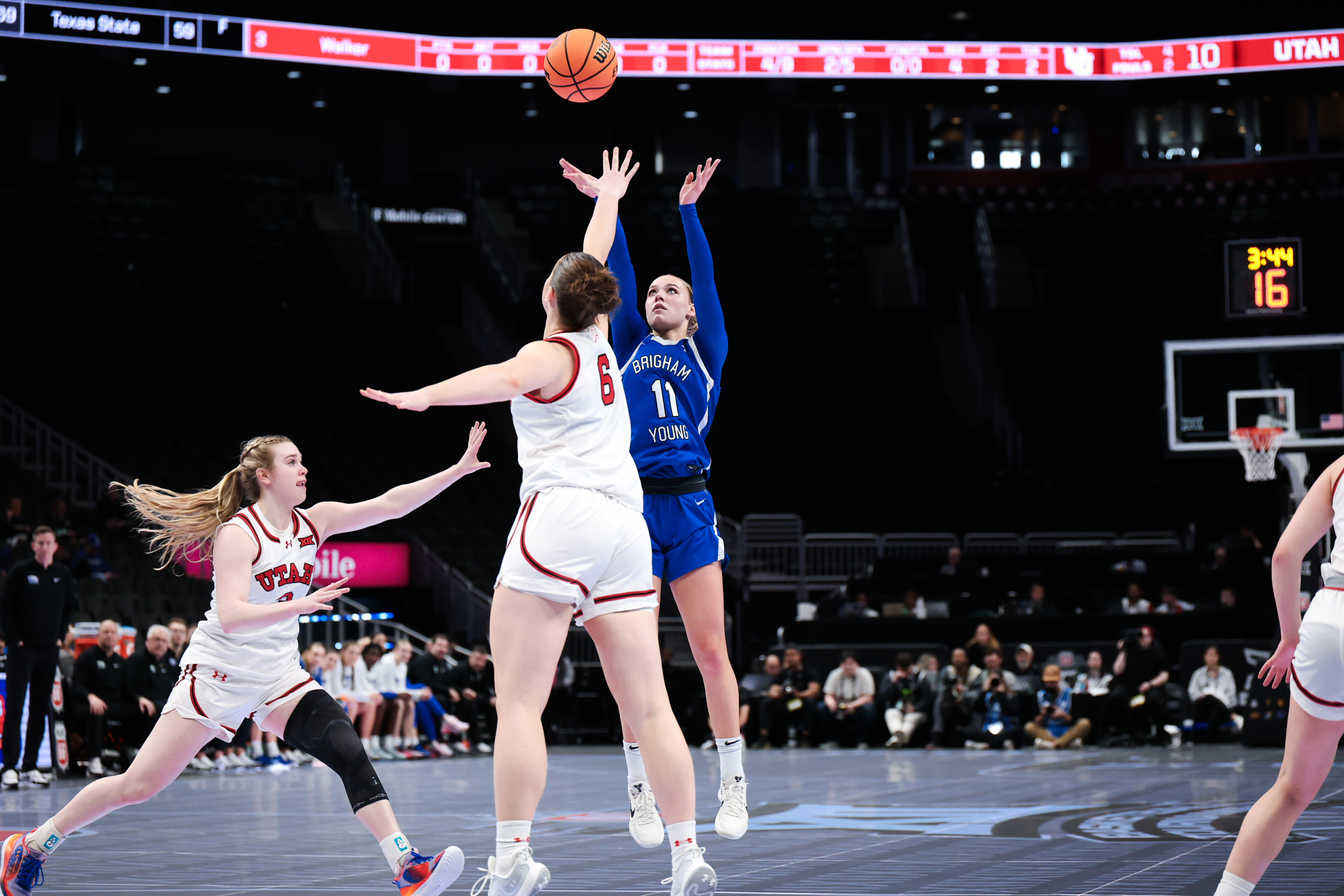 BYU guard Delaney Gibb (11) raises up for a 3-point shot over Utah's Evelina Otto (6) in the second round of the Big 12 women's basketball tournament in Kansas City on March 5, 2026.