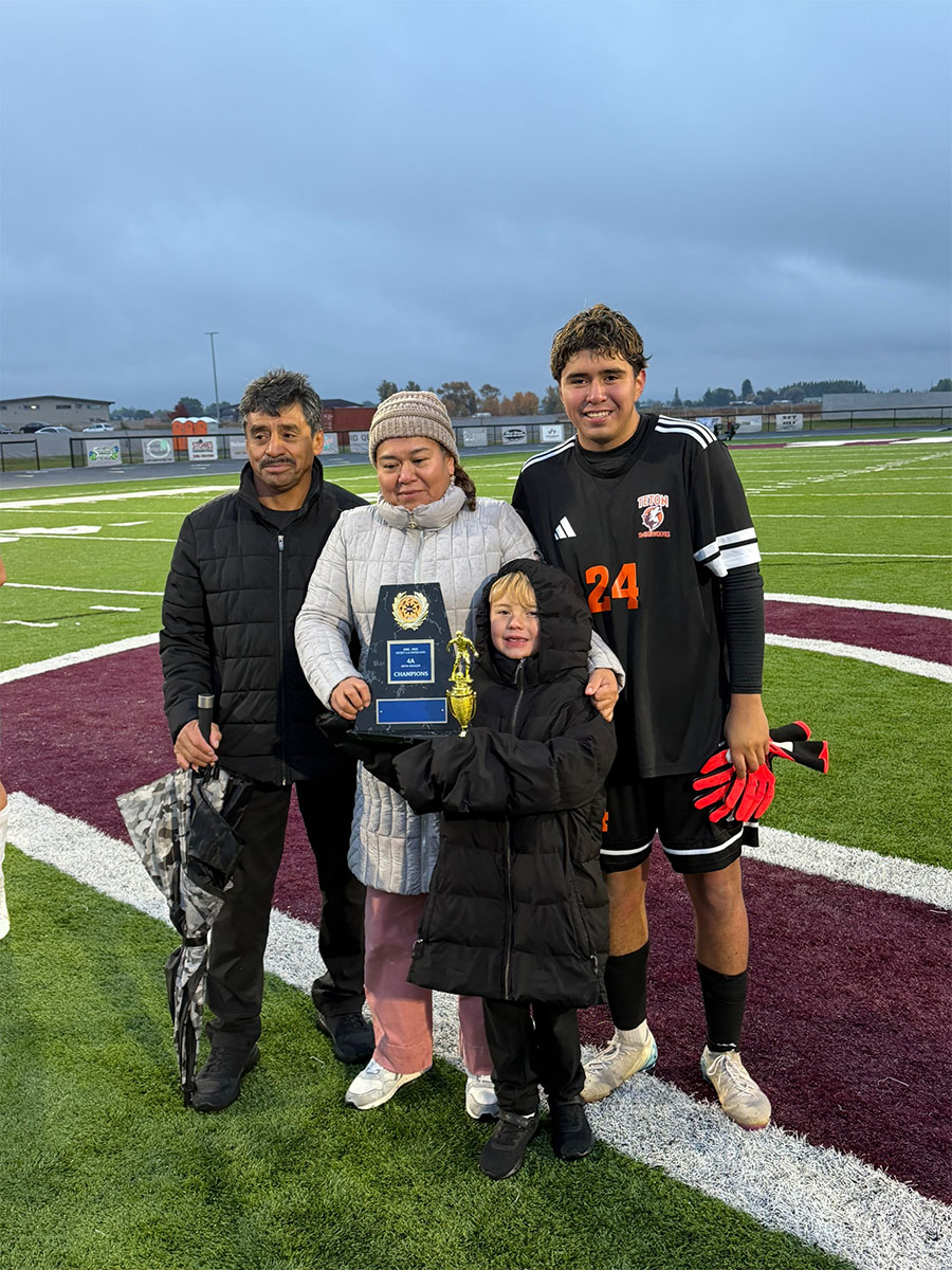 Kirby Martinez with his parents and his nephew. Martinez will travel to the Rome City Institute starting in September on a scholarship to play soccer.