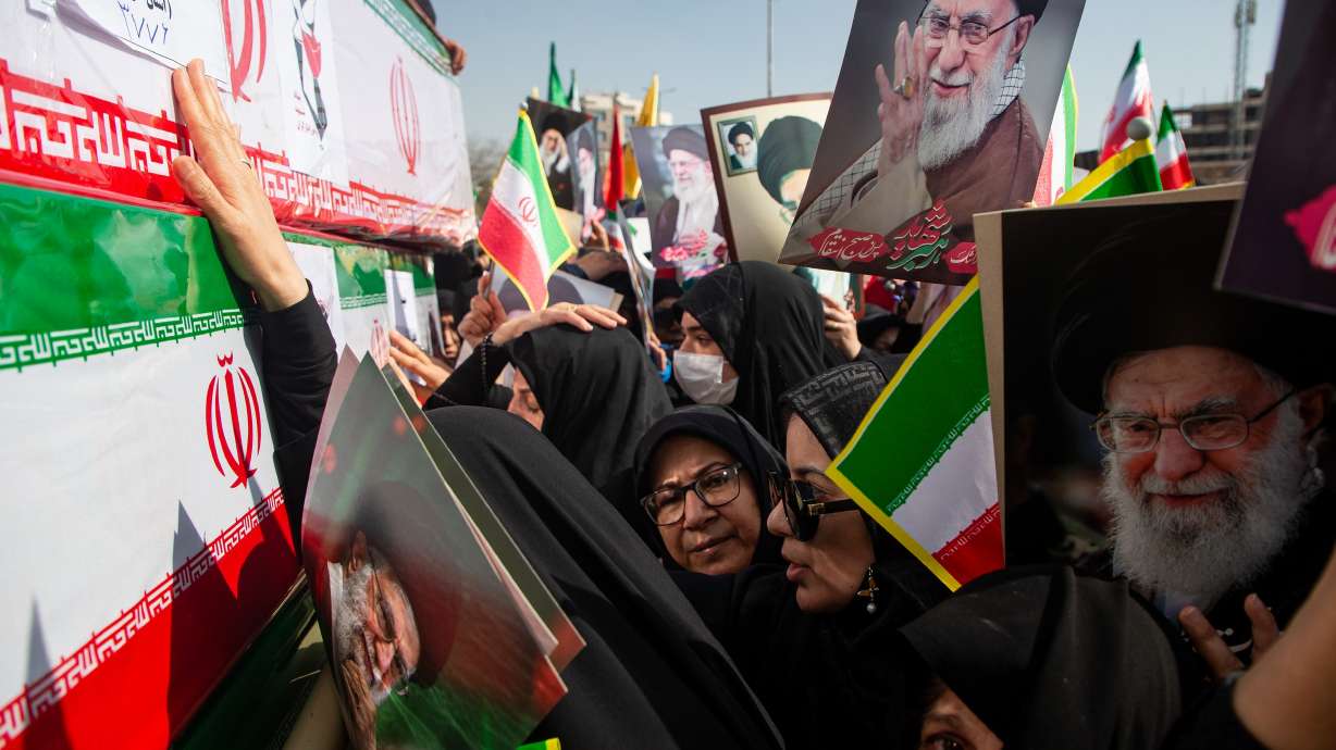 Some holding pictures of the late Iranian Supreme Leader Ayatollah Ali Khamenei, mourners reach out to coffins during a funeral for people killed during the ongoing U.S.–Israeli military campaign in Isfahan, Iran, Thursday.