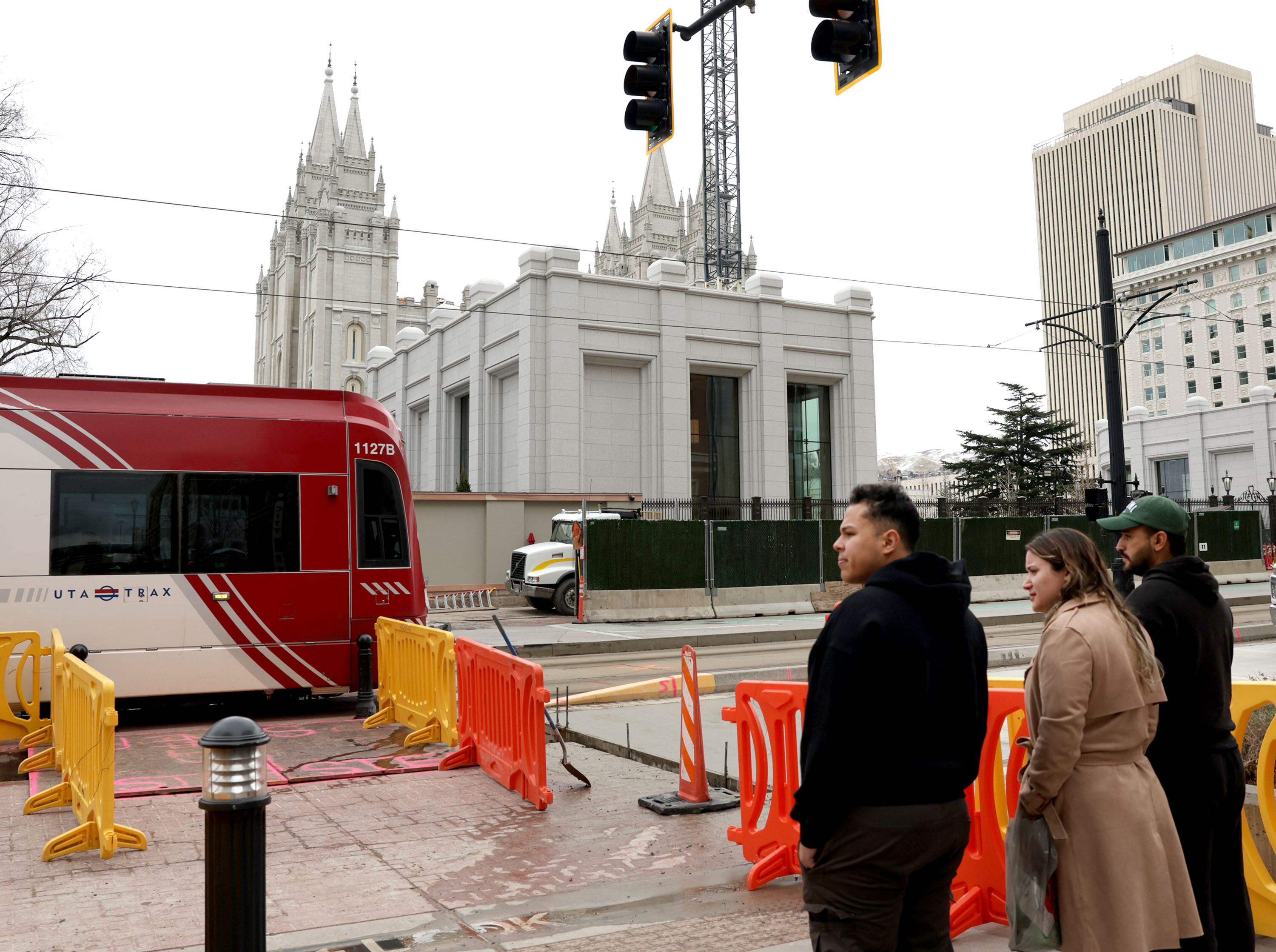 Pedestrians wait to cross South Temple toward Temple Square in Salt Lake City on Thursday. The Salt Lake City Council is considering an ordinance that would temporarily close a few downtown road segments for "public safety and crowd management" from April to October in 2027 due to the reopening of the Salt Lake Temple.