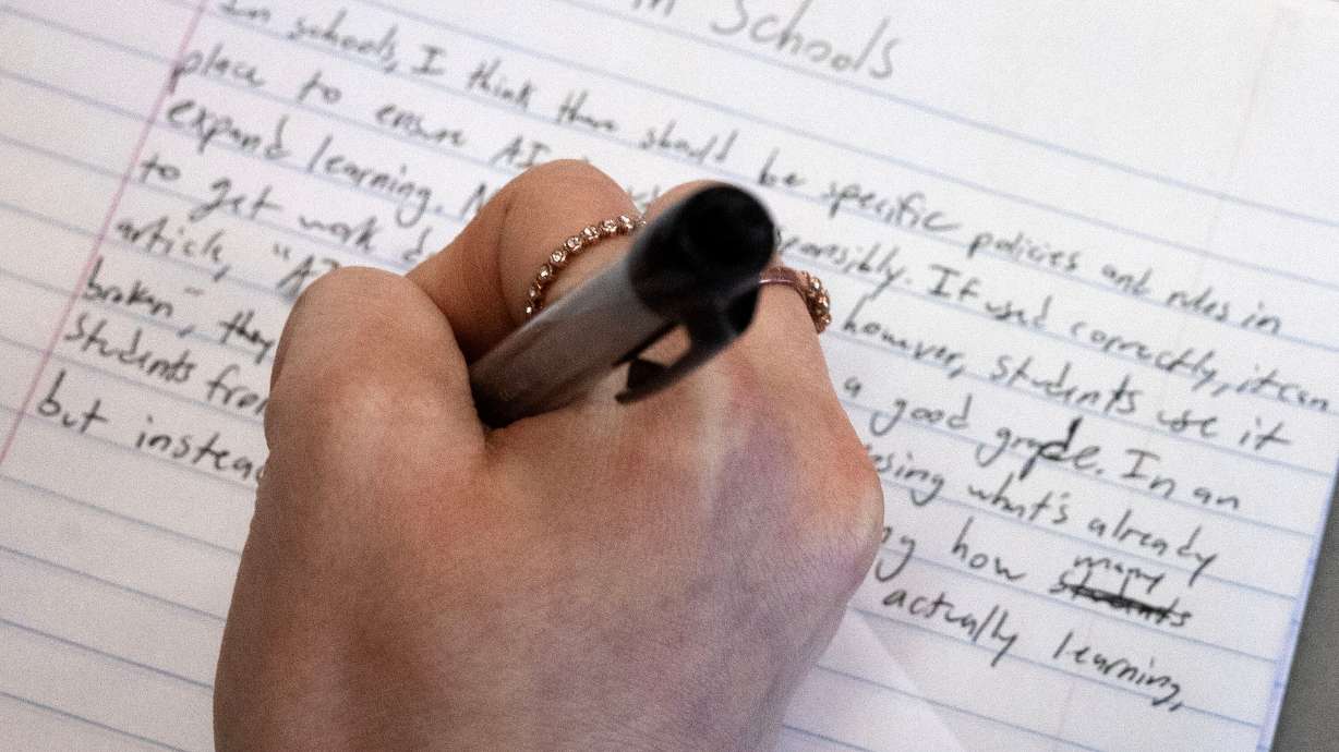 A student writes a paper about artificial intelligence at Jordan High School in Sandy on Jan. 15. Sen. John Johnson, R-North Ogden, is proposing the creation of a new "regulatory sandbox" to evaluate AI programs before usage in education.