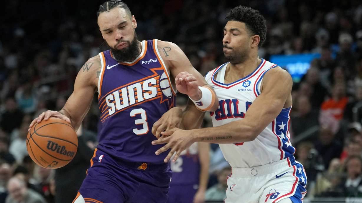 Phoenix Suns forward Dillon Brooks (3) dribbles the ball against Philadelphia 76ers guard Quentin Grimes during the second half of an NBA basketball game Saturday, Feb. 7, 2026, in Phoenix.