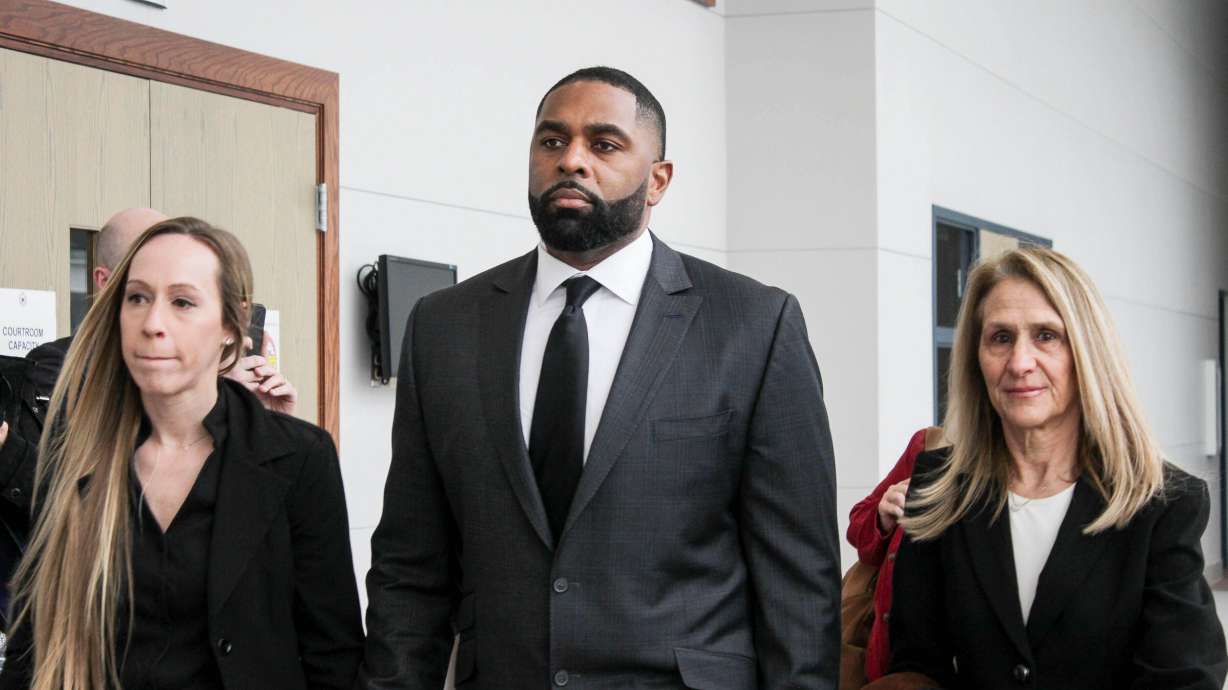 Former Michigan football coach Sherrone Moore arrives for a court hearing with his wife, Kelli Moore, left, and attorney Ellen Michaels, Friday, March 6 2026, at Washtenaw County 14A-1 District in Ann Arbor, Mich.